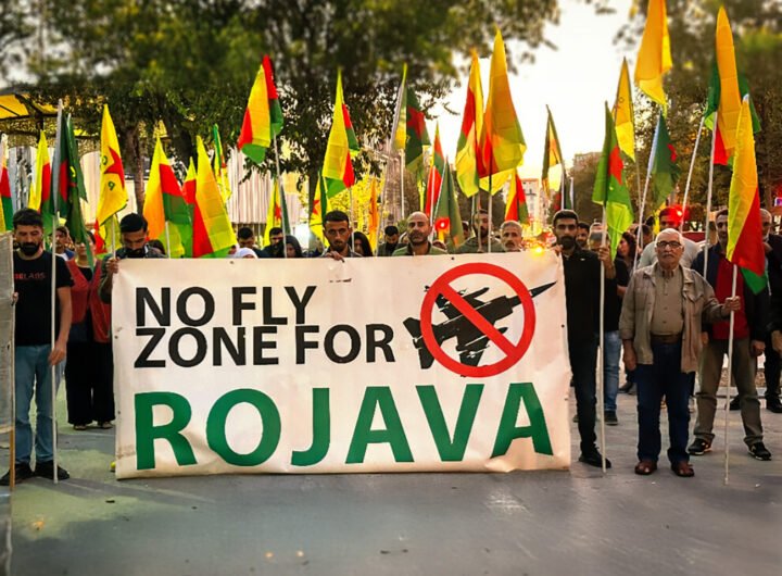 Protestmars met demonstranten die Rojava ondersteunen, met een groot spandoek met de tekst ‘No Fly Zone for Rojava’.