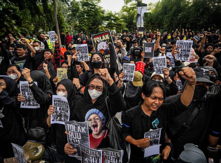 Demonstranten in Surabaya protesteren massaal tegen nieuwe militaire wet in Indonesië, met spandoeken en geheven vuiste
