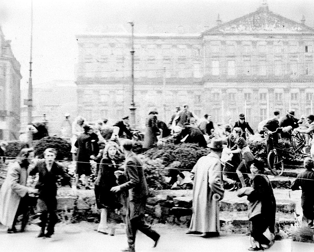 Mensen vluchten voor kogels op de Dam in Amsterdam tijdens schietpartij op 7 mei 1945