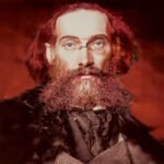 Portret van Gustav Landauer rond 1910 met bril en volle baard, kijkend recht in de camera.