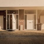 Straatportiek met meerdere deuren in Amsterdam, symboliserend lange wachttijden voor sociale huurwoningen en de strijd om woonzekerheid.