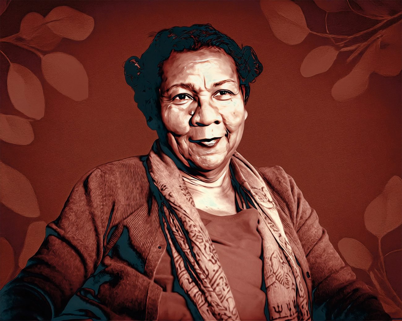 Portret van bell hooks in 2018, zittend en kijkend naar de camera, tegen een warme achtergrond met bladmotieven.